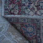 1970s red vintage turkish rug with floral design, hand-knotted weave and low pile.
