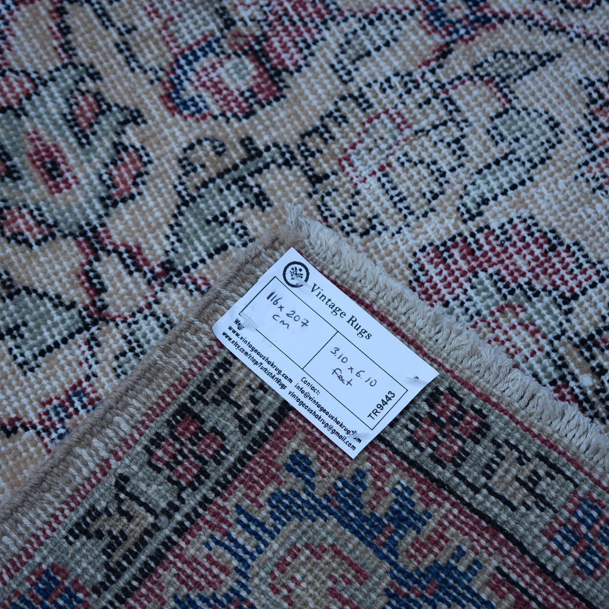Red 4' x 7' vintage turkish rug from the 1970s with floral design.
