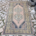 Yellow 4' x 7' vintage turkish rug in wool and cotton, shown on the floor.
