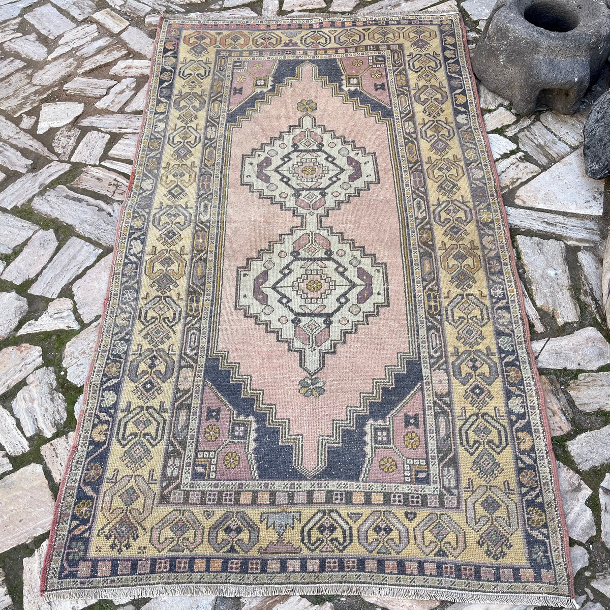 Yellow 4' x 7' vintage turkish rug in wool and cotton, shown on the floor.