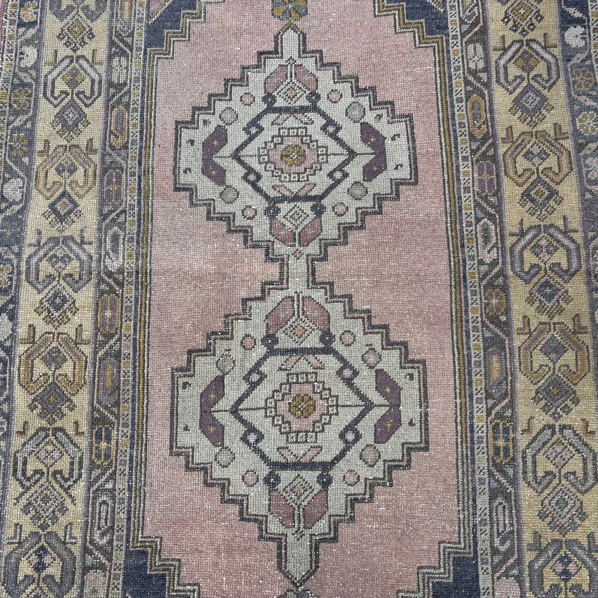 1970s yellow vintage turkish rug with geometric design, hand-knotted weave and low pile.