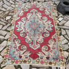 Yellow 4' x 7' vintage turkish rug in wool and cotton, shown on the floor.