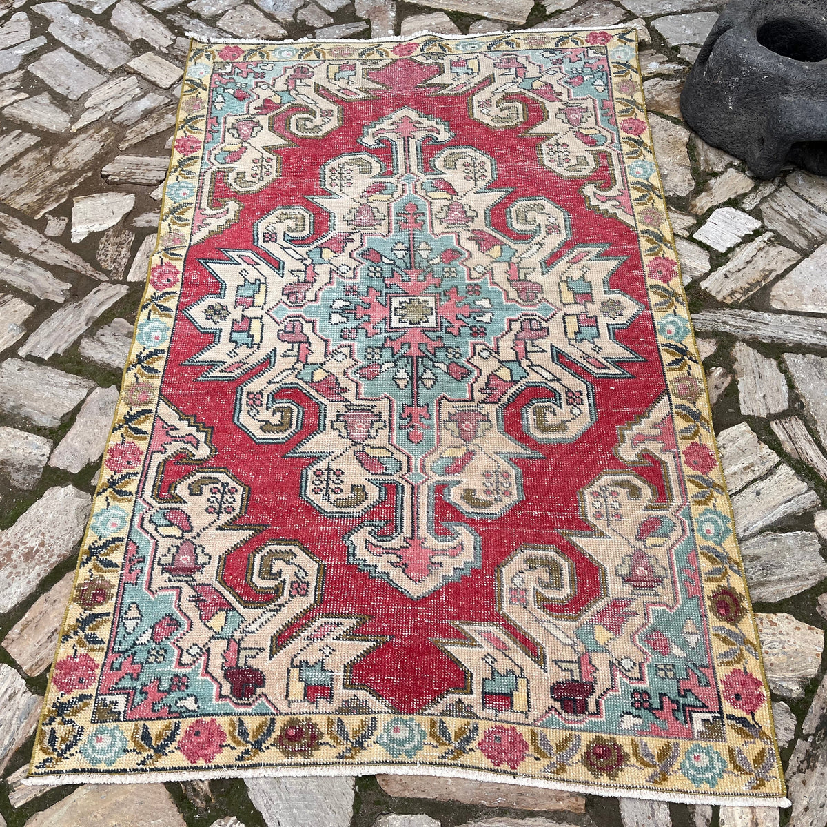 Yellow 4' x 7' vintage turkish rug in wool and cotton, shown on the floor.