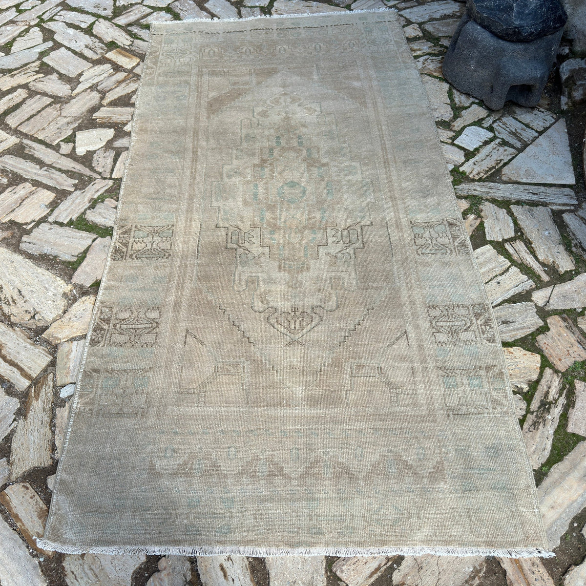 Beige 4' x 8' vintage turkish rug in wool and cotton, shown on the floor.