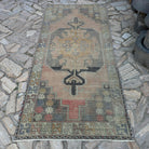 Beige 4' x 8' vintage turkish rug in wool and cotton, shown on the floor.
