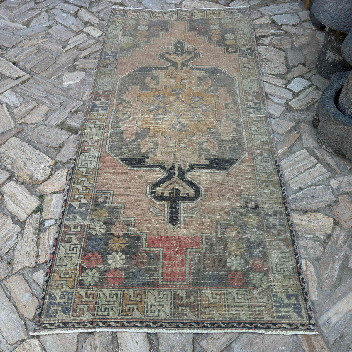 Beige 4' x 8' vintage turkish rug in wool and cotton, shown on the floor.