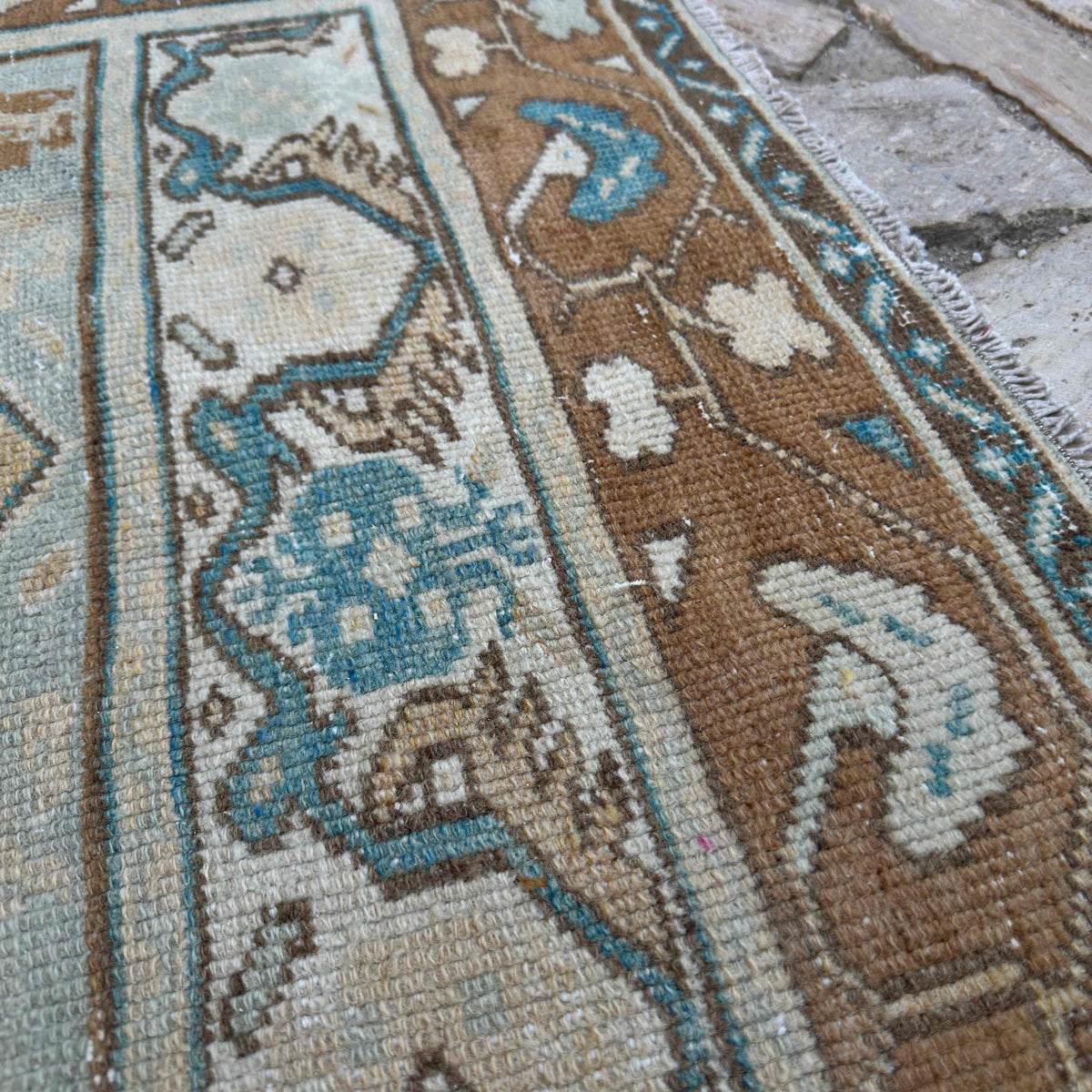 Close-up of the brown vintage turkish rug showing traditional details, hand-knotted weave, wool and cotton and low pile.