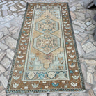 Brown 4' x 8' vintage turkish rug in wool and cotton, shown on the floor.