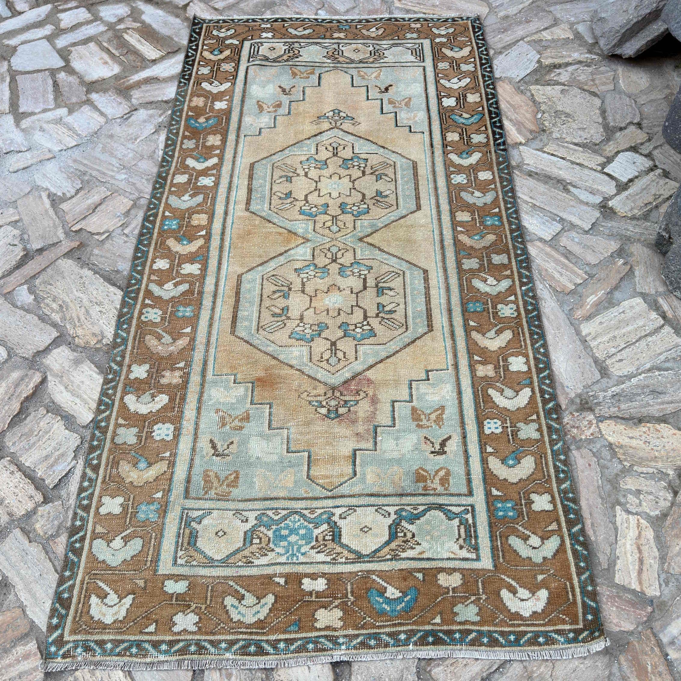 Brown 4' x 8' vintage turkish rug in wool and cotton, shown on the floor.