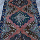 Close-up of the orange vintage turkish rug showing traditional details, hand-knotted weave, wool and cotton and low pile.