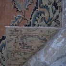1970s orange vintage turkish rug with geometric design, hand-knotted weave and low pile.