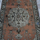 Close-up of the orange vintage turkish rug showing traditional details, hand-knotted weave, wool and cotton and low pile.