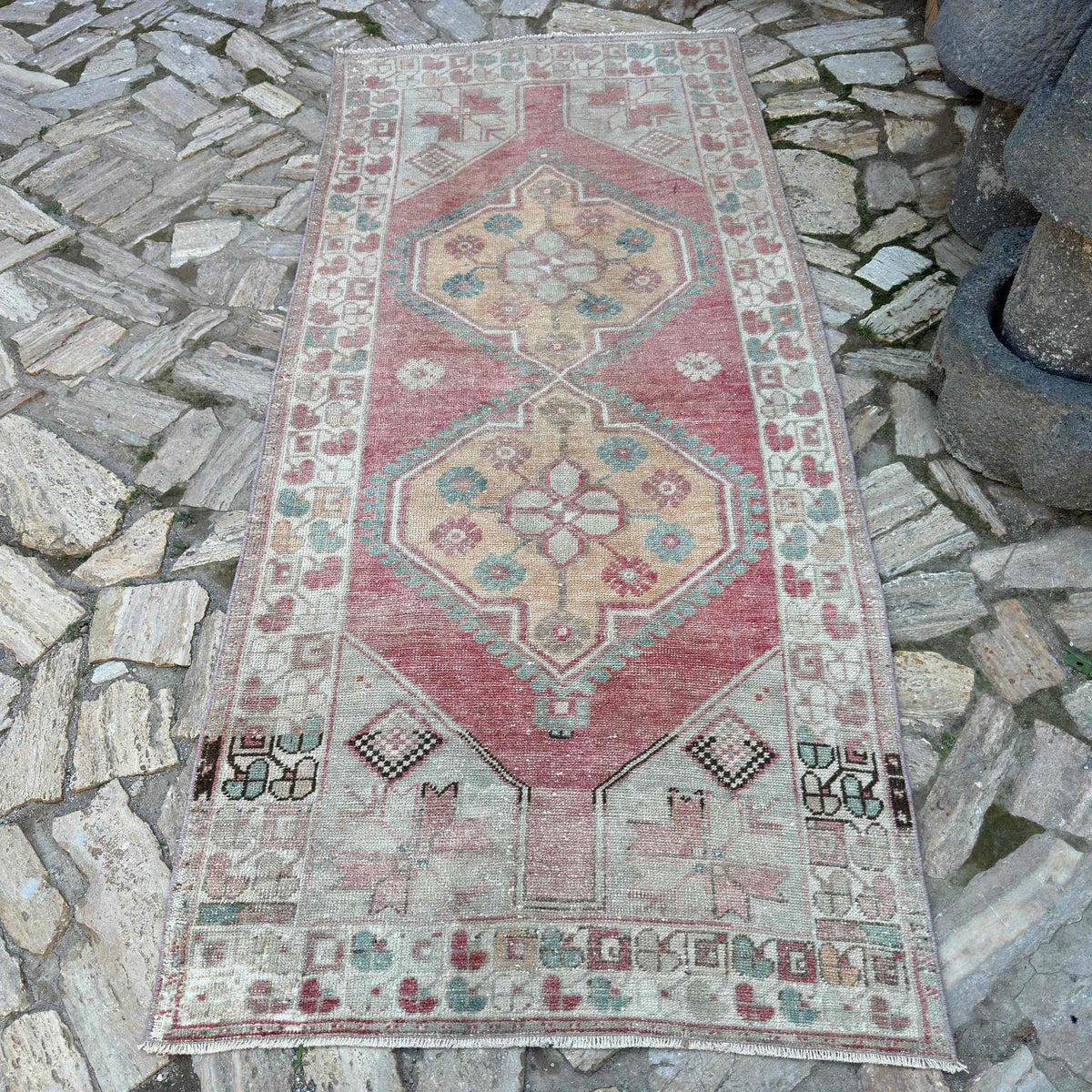 Pale Pink 4' x 8' vintage turkish rug in wool and cotton, shown on the floor.