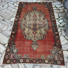 Pale Red 4' x 8' vintage turkish rug in wool and cotton, shown on the floor.