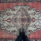1970s pale red vintage turkish rug with medallion design, hand-knotted weave and low pile.