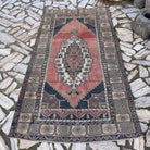 Pale Red 4' x 8' vintage turkish rug in wool and cotton, shown on the floor.