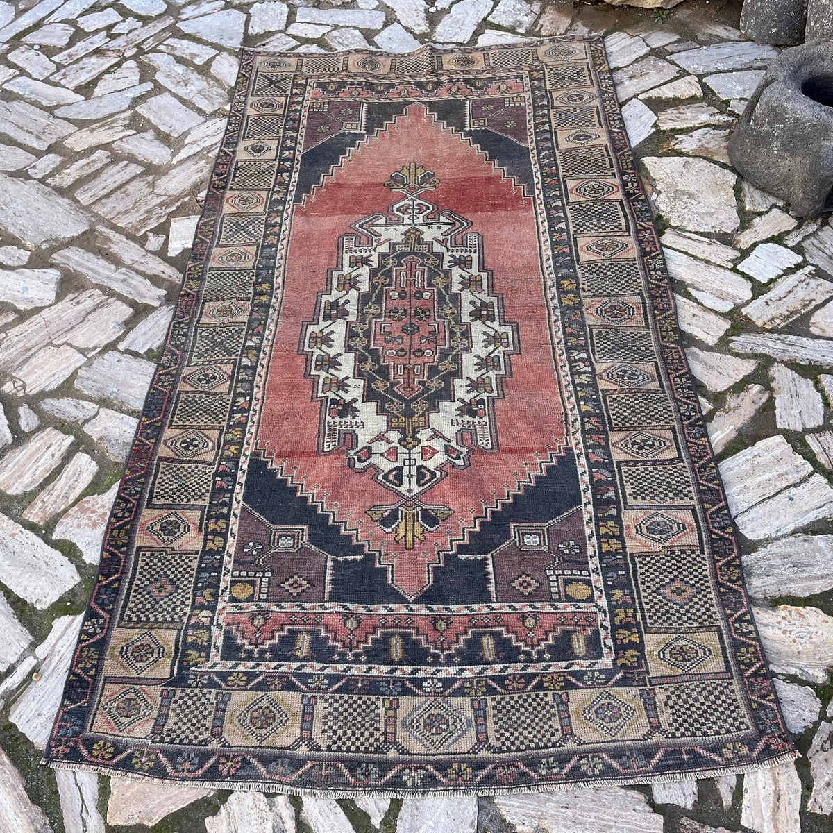 Pale Red 4' x 8' vintage turkish rug in wool and cotton, shown on the floor.