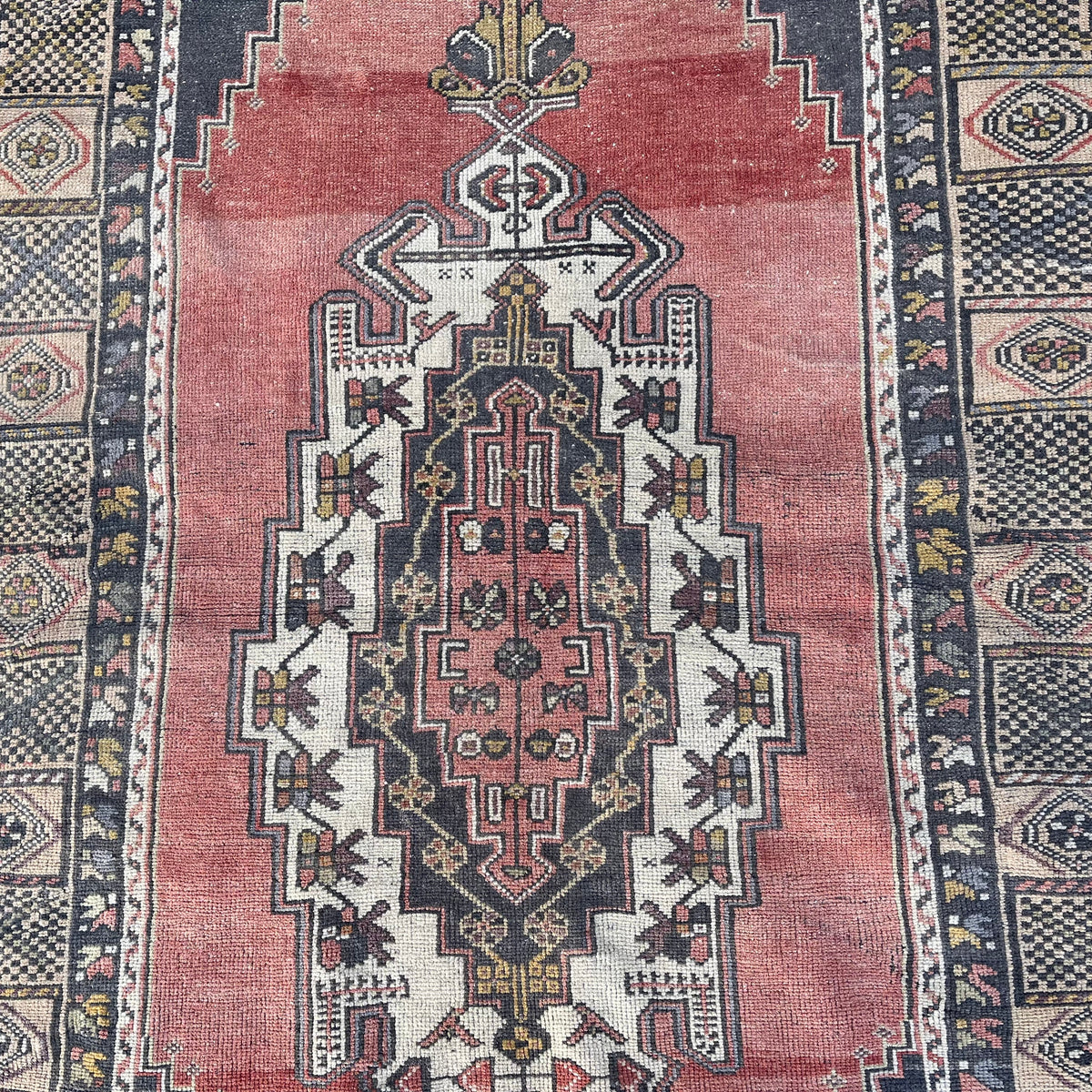 1970s pale red vintage turkish rug with traditional design, hand-knotted weave and low pile.
