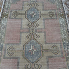 Pink 4' x 8' vintage turkish rug in wool and cotton, shown on the floor.