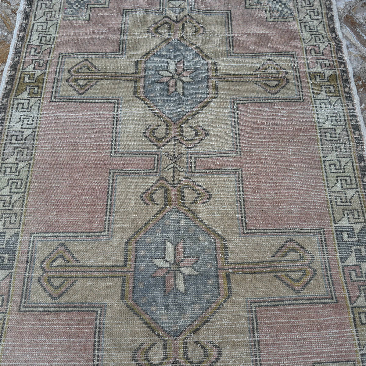 Pink 4' x 8' vintage turkish rug in wool and cotton, shown on the floor.