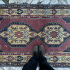 1970s red vintage turkish rug with geometric design, hand-knotted weave and low pile.