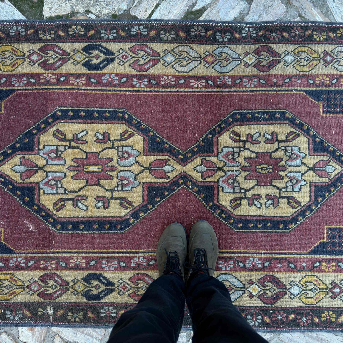 1970s red vintage turkish rug with geometric design, hand-knotted weave and low pile.