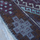 Brown 4' x 9' vintage turkish rug in wool and cotton, shown on the floor.