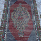 Close-up of the red vintage turkish rug showing traditional details, hand-knotted weave, wool and low pile.