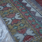 Red 4' x 9' vintage turkish rug in wool, shown on the floor.