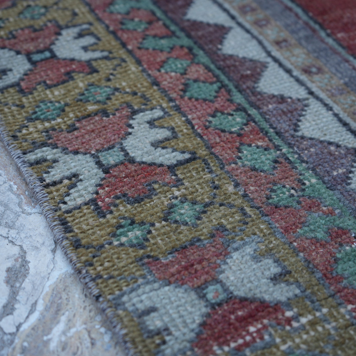 Red 4' x 9' vintage turkish rug in wool, shown on the floor.