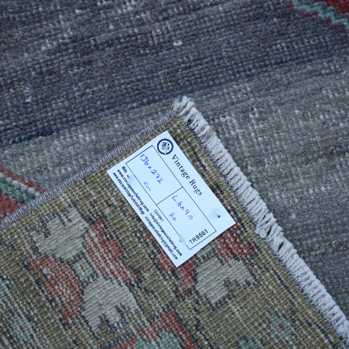Red 4' x 9' vintage turkish rug from the 1970s with traditional design.