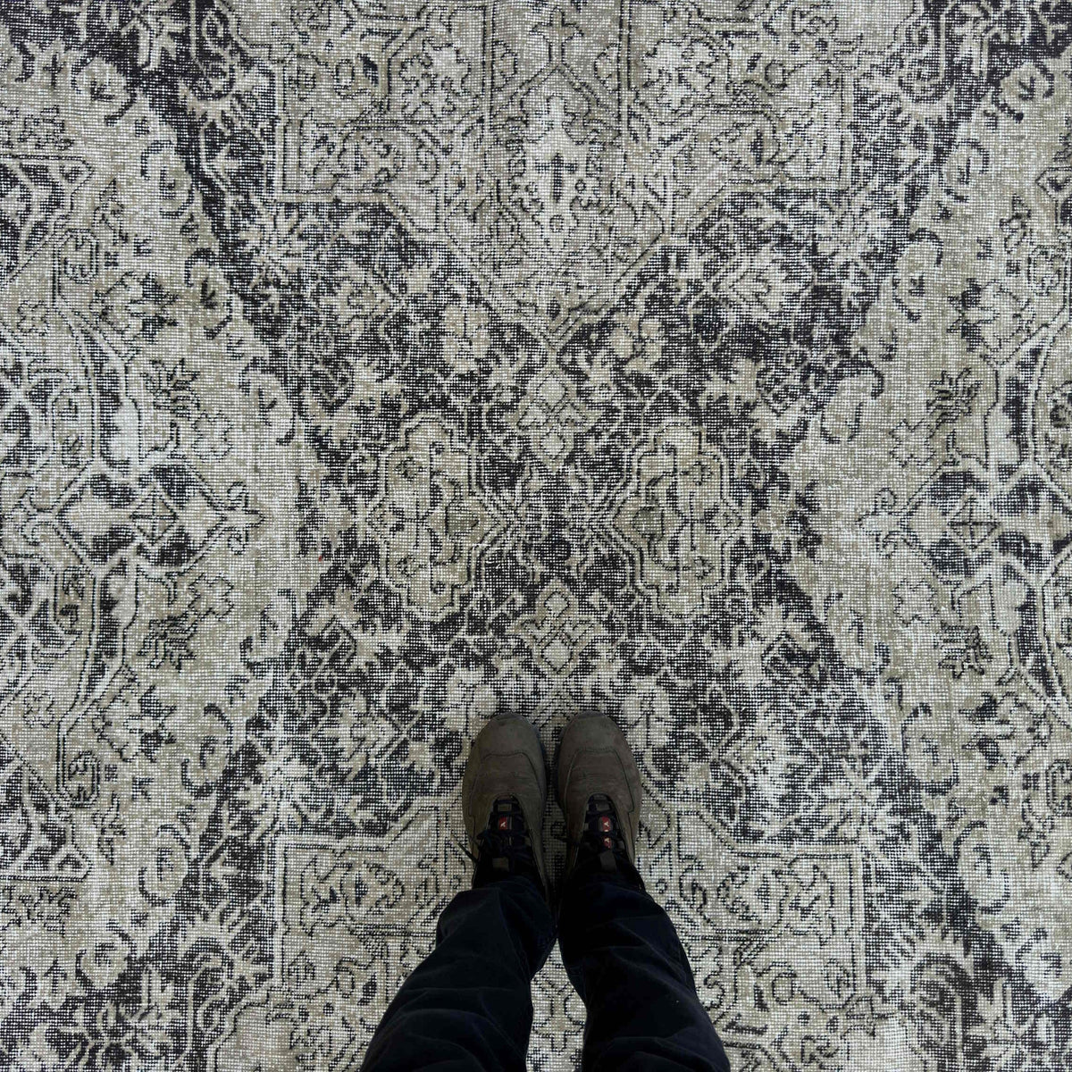 1970s black vintage turkish rug with neutral design, hand-knotted weave and low pile.