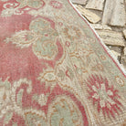 Close-up of the red vintage turkish rug showing traditional details, hand-knotted weave, wool and cotton and low pile.