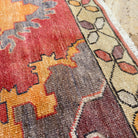 Close-up of the red vintage turkish rug showing traditional details, hand-knotted weave, wool and cotton and low pile.