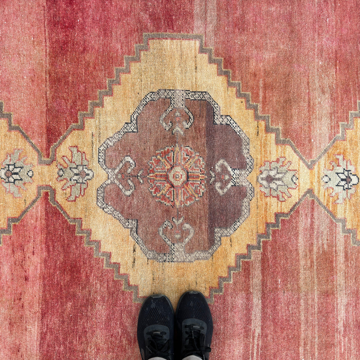 1970s red vintage turkish rug with traditional design, hand-knotted weave and low pile.