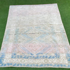 Blue 5' x 6' vintage turkish rug in wool and cotton, shown on the floor.