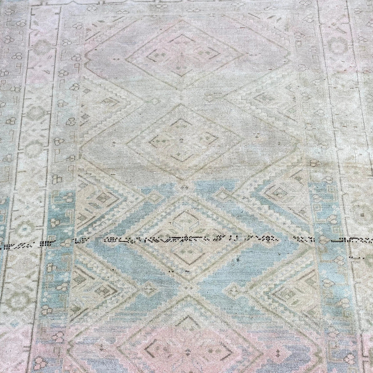1970s blue vintage turkish rug with geometric design, hand-knotted weave and low pile.