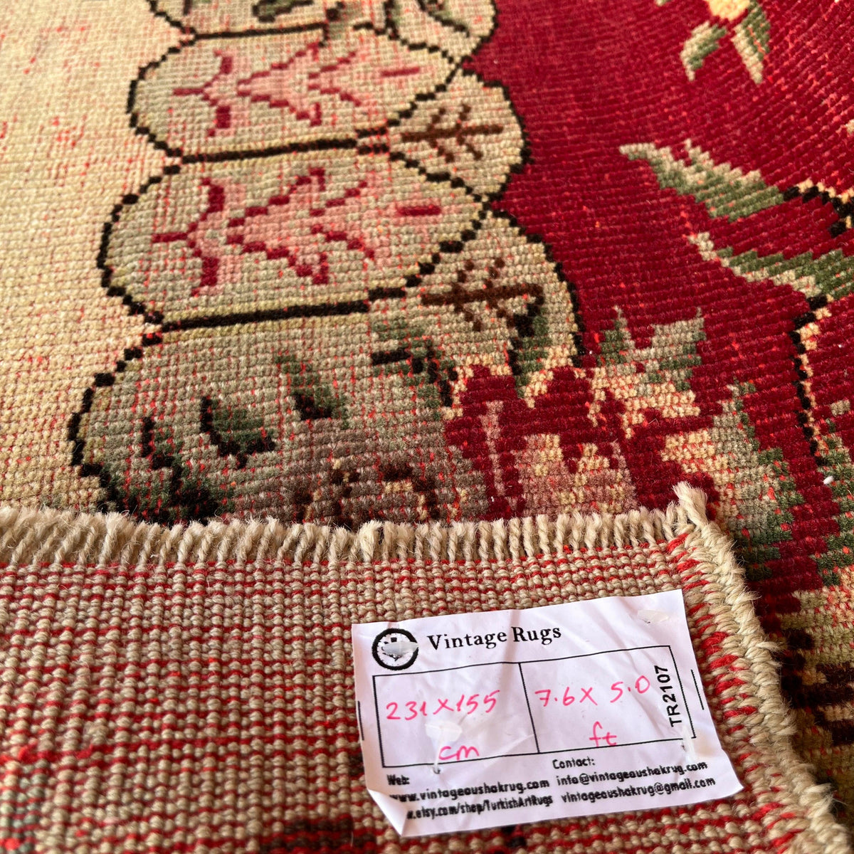 Close-up of the red vintage turkish rug showing traditional details, hand-knotted weave, wool and cotton and low pile.