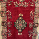 Red 5' x 7' vintage turkish rug in wool and cotton, shown on the floor.