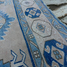 Close-up of the blue vintage turkish rug showing traditional details, hand-knotted weave, wool and cotton and low pile.