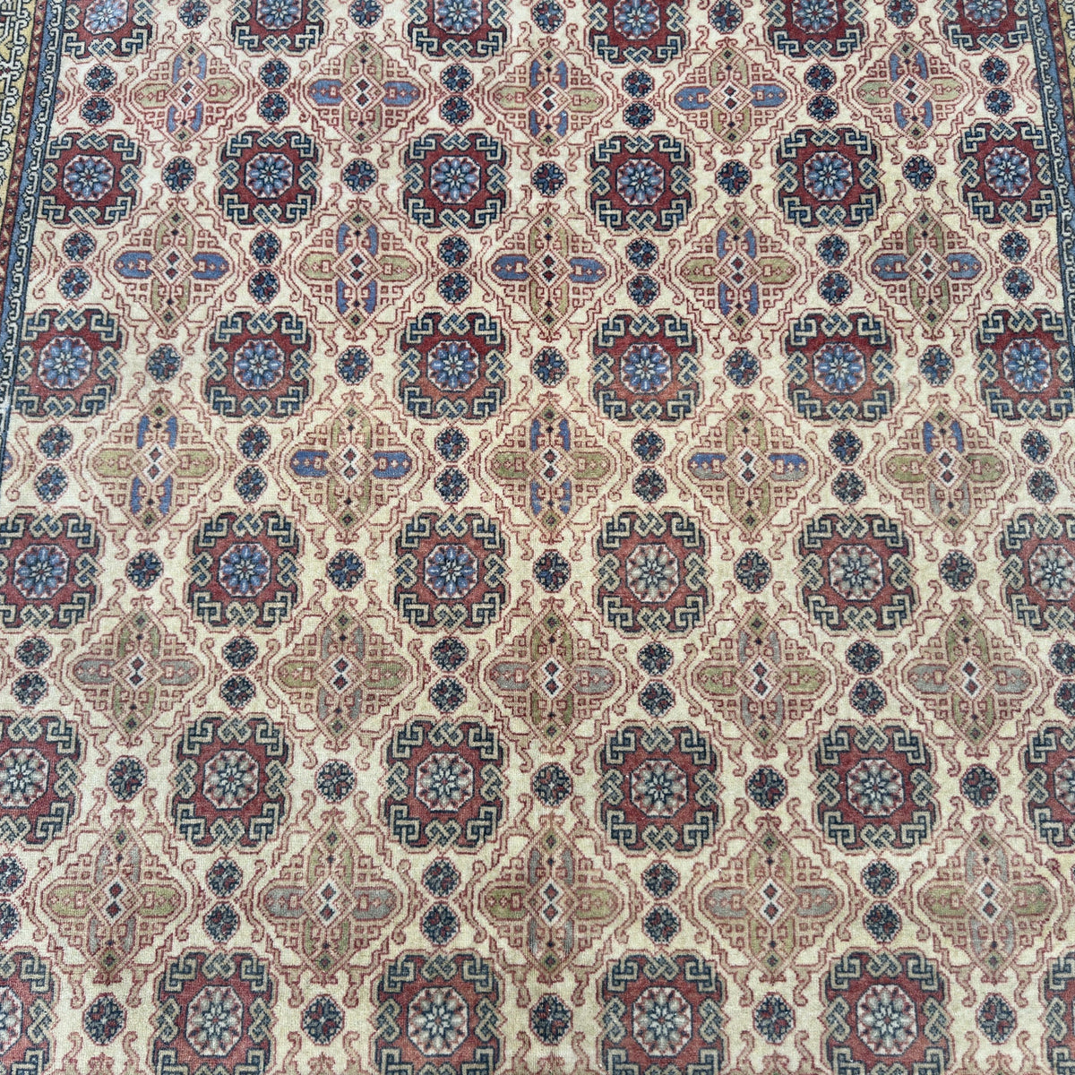 1970s pale red vintage turkish rug with traditional design, hand-knotted weave and low pile.