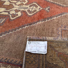 Close-up of the red vintage turkish rug showing traditional details, hand-knotted weave, wool and cotton and low pile.