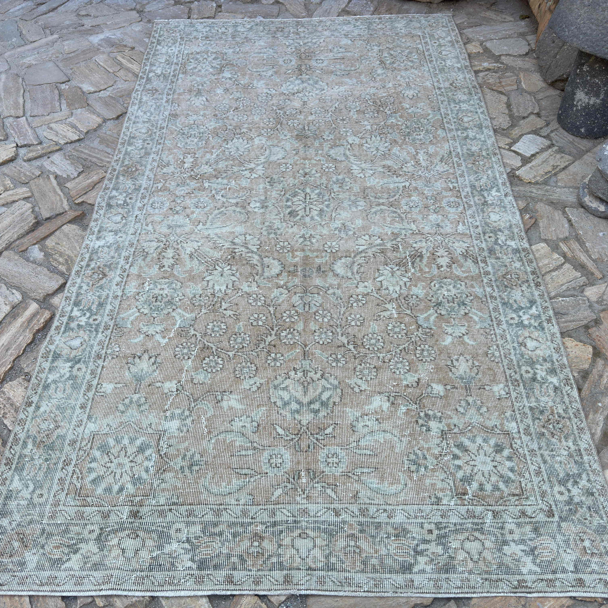 Beige 5' x 9' vintage turkish rug in wool and cotton, shown on the floor.