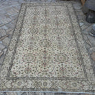 Brown 5' x 9' vintage turkish rug in wool and cotton, shown on the floor.