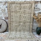 Brown 5' x 9' vintage turkish rug with floral design, handmade in Turkey – Ivy.