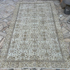 Brown 5' x 9' vintage turkish rug in wool and cotton, shown on the floor.