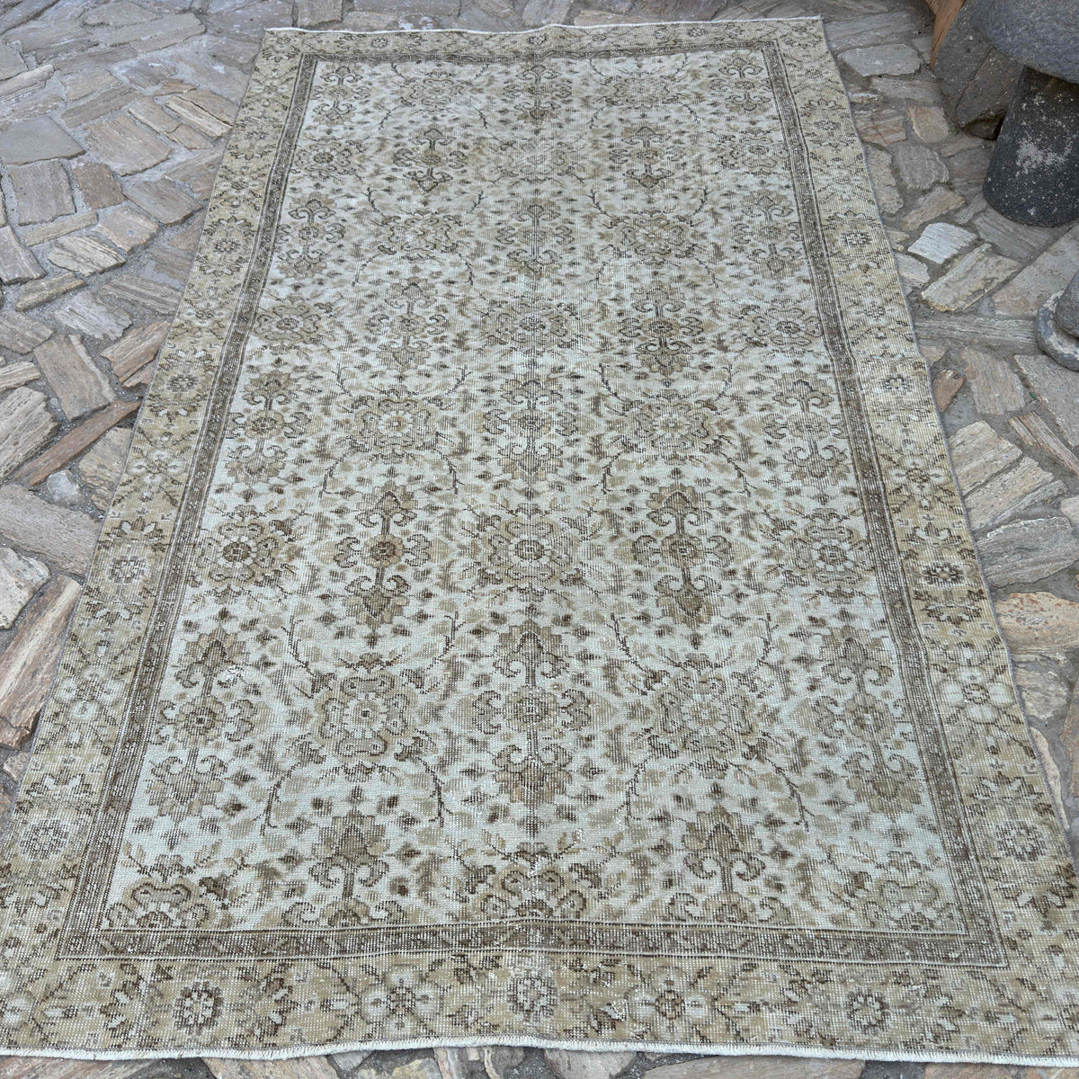 Brown 5' x 9' vintage turkish rug in wool and cotton, shown on the floor.