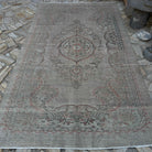 Beige 6' x 10' vintage turkish rug in wool and cotton, shown on the floor.