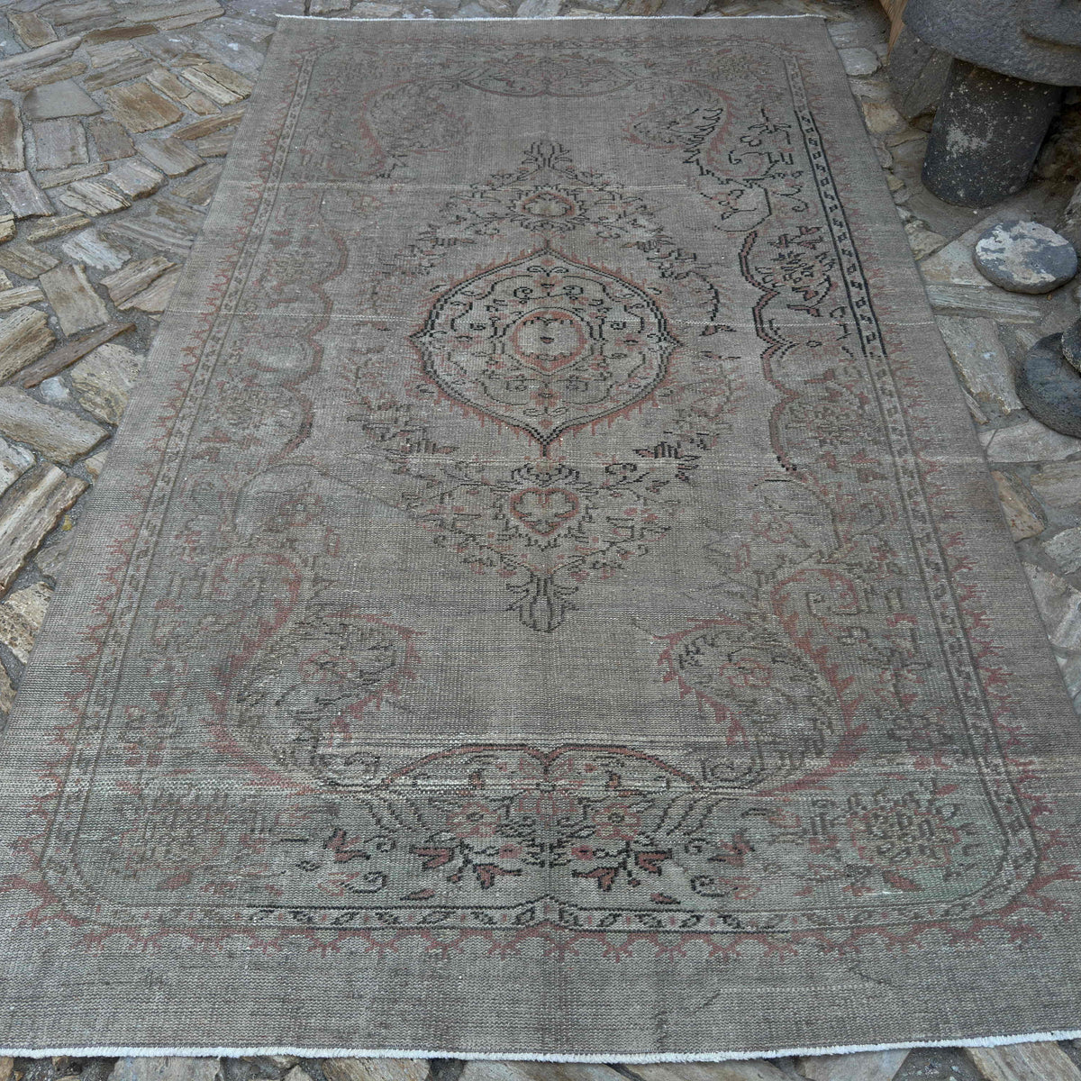 Beige 6' x 10' vintage turkish rug in wool and cotton, shown on the floor.
