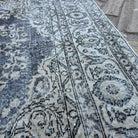 Close-up of the beige vintage turkish rug showing medallion details, hand-knotted weave, wool and cotton and low pile.